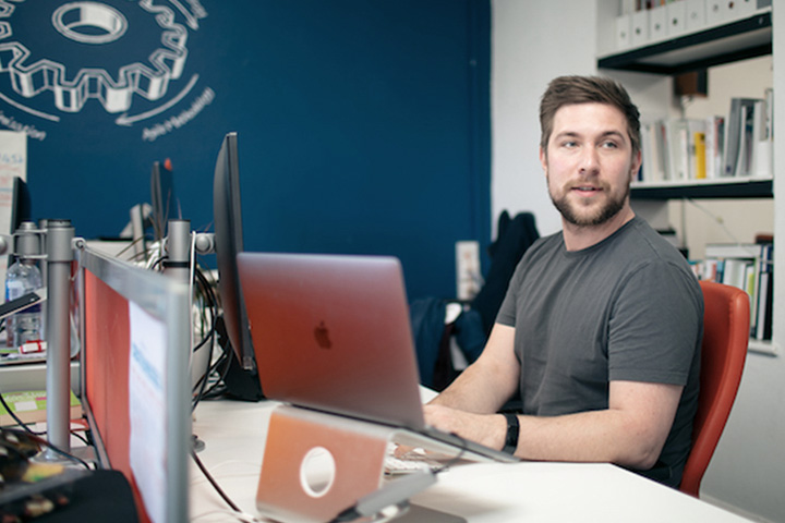 UX Design Lead at desk with computer in front of him