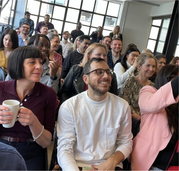 A photo of the audience at the BIMA event from the perspective of the panellists. There is a diverse mix of people and they look very animated, all taking part in the discussion about accessibility.