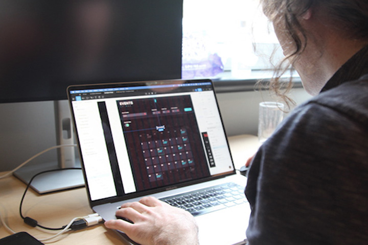 Looking over the shoulder of a designer working on his computer