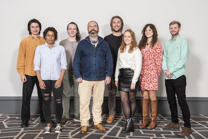 8 members of the UX and Design team smiling