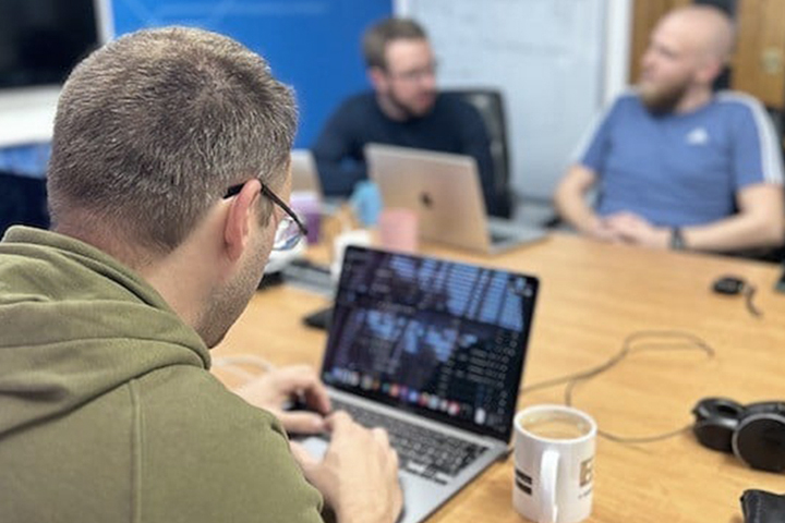 Three developers working in a meeting room
