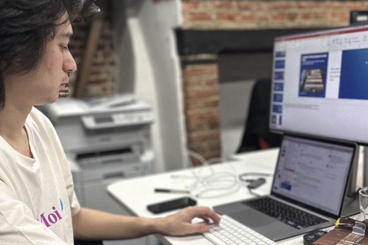 UX Design working on his laptop in an office