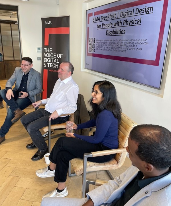 Panellists Matt, Paul, Meera and Yahye sitting in a row of chairs in front of the audience at the BIMA event. They are all smiling and it looks like there is a lively discussion going on.