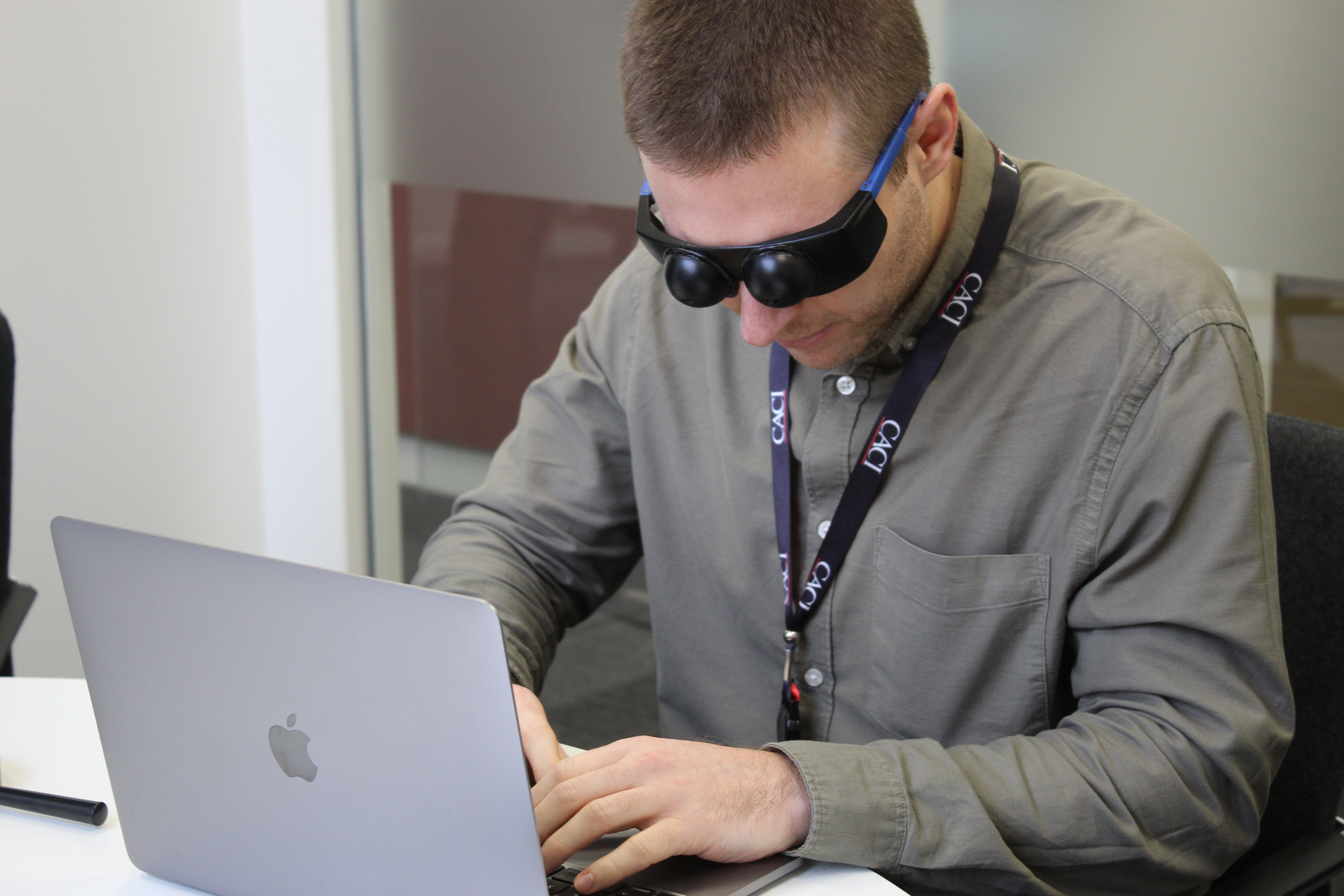 CACI Inclusion Lab image showing person using a glasses style technology to simulate visual impairment
