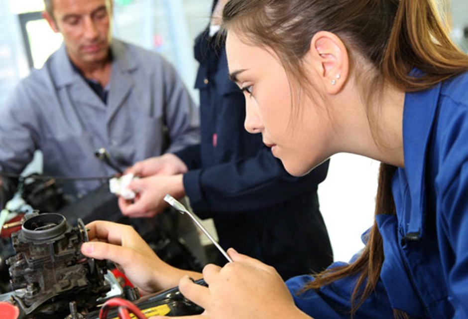 Female Mechanic repairing a carburettor on a car engine