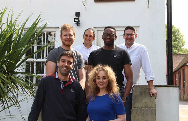 Seven executive directors of Cyber-Duck standing on the steps to the Elstree office