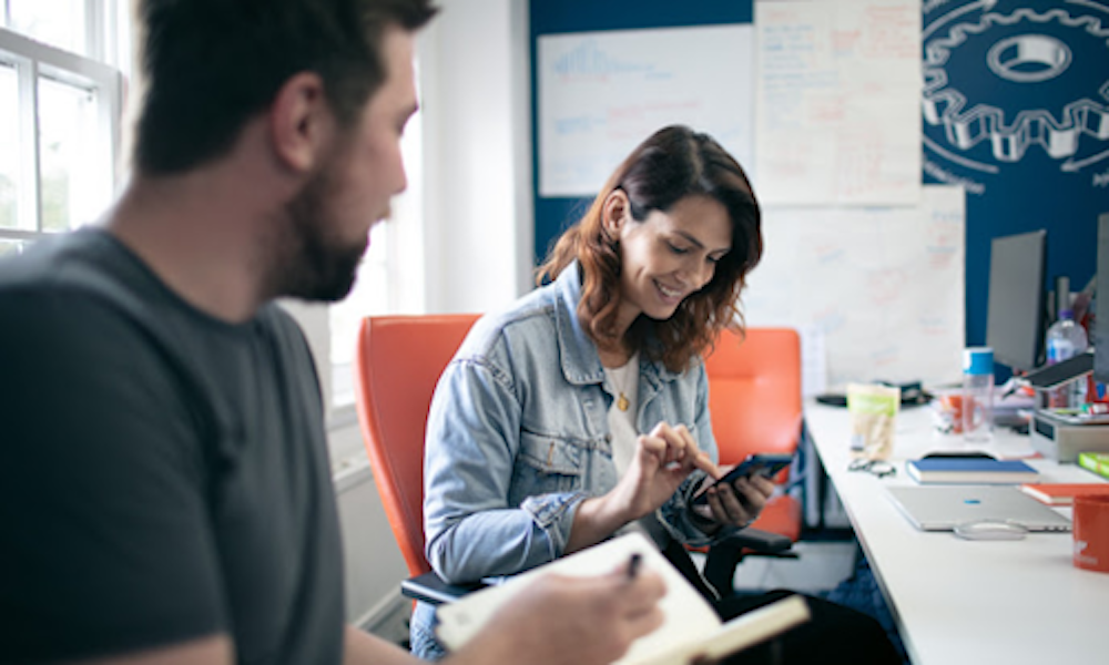 Designers collaborating on mobile project