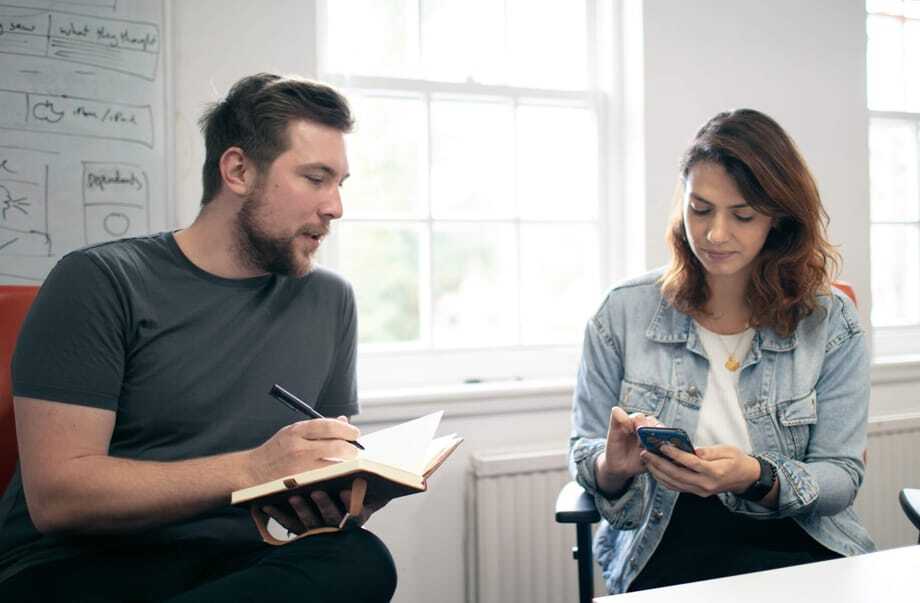 Photo of James and Fabiola conducting usability testing and assessing prototype