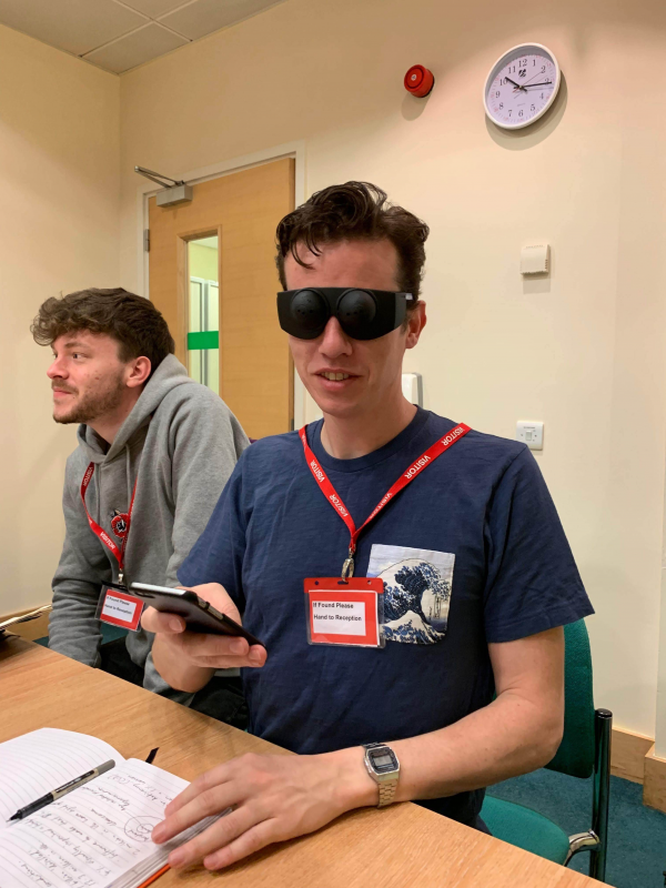 Sam, our UX Director, at the RNIB wearing tunnel vision glasses
