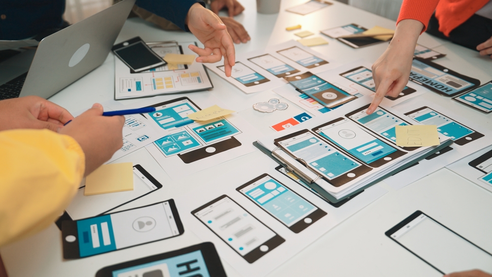 Service Design workshop working on mobile screen user journey flows 