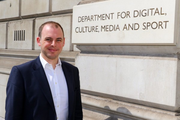 Matt Warman MP, Minister for Digital Infrastructure, standing in front of the Department for Digital, Culture, Media and Sport.