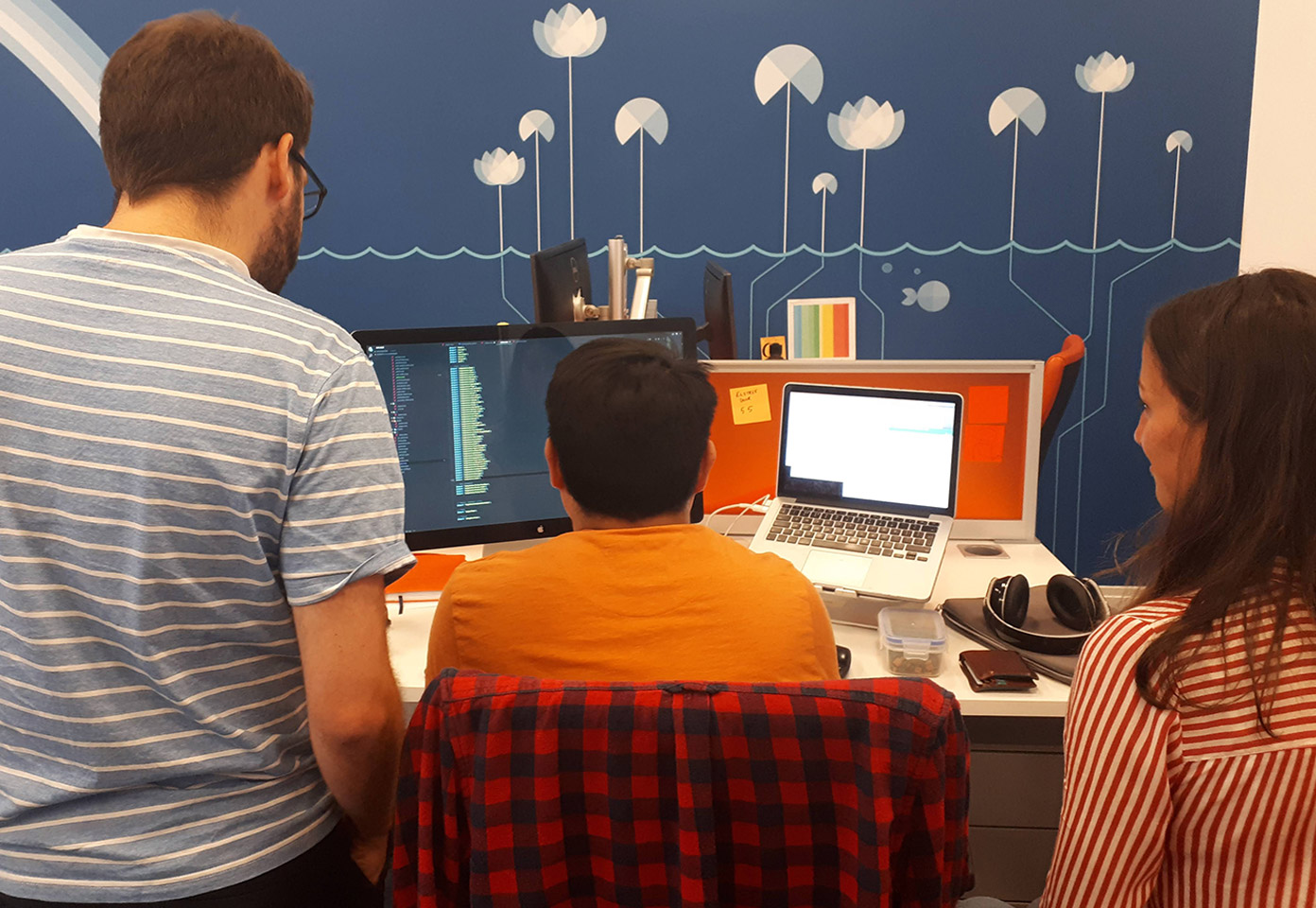 Three designers viewing our user centred design process