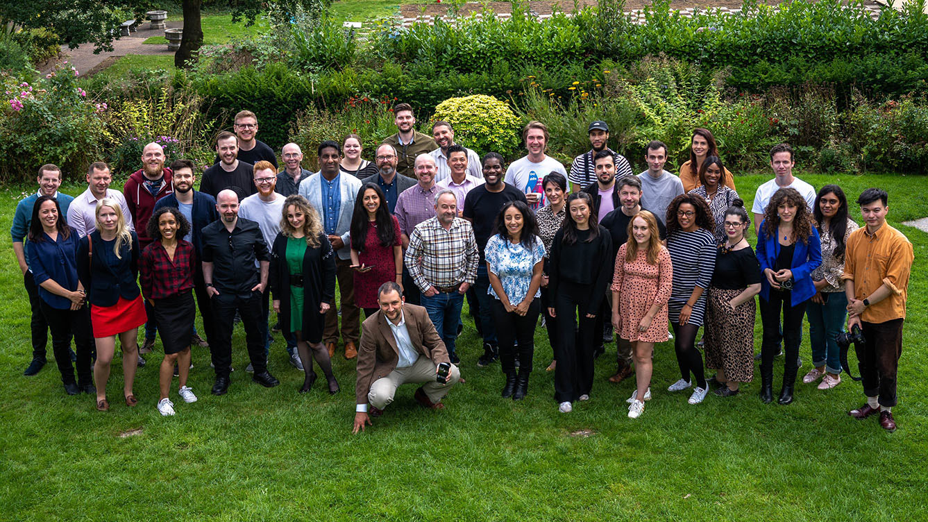 Some of the team at Cyber-Duck standing together in a green garden