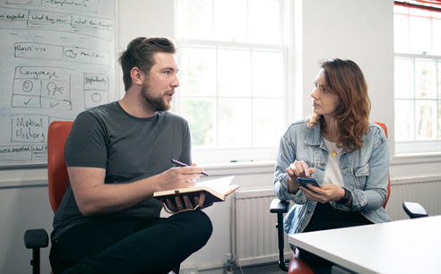 Photo of James and Fabiola conducting usability testing and assessing prototype