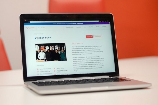 An image of a laptop with the Cyber-Duck website, showing that we are Laravel partners.