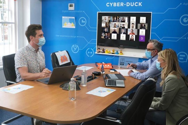 three people hosting a zoom meeting with masks on