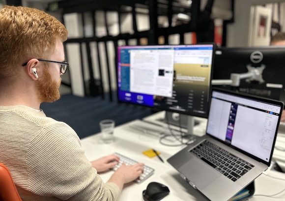 Photo of a Cyber-Duck employee working on a frontend design at his workstation