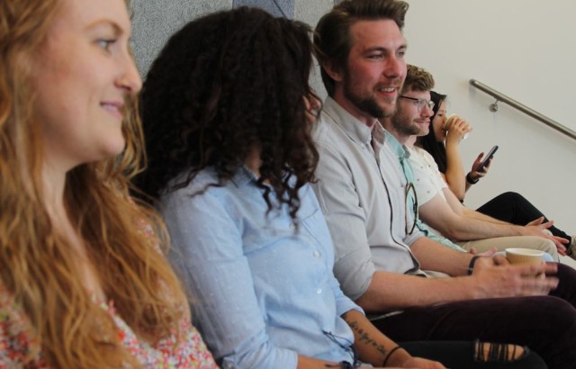 Photo of James Martin sitting in a row of seats with other members of the design team