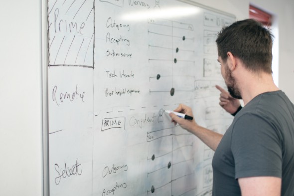 Photo of James planning out a design on a white board