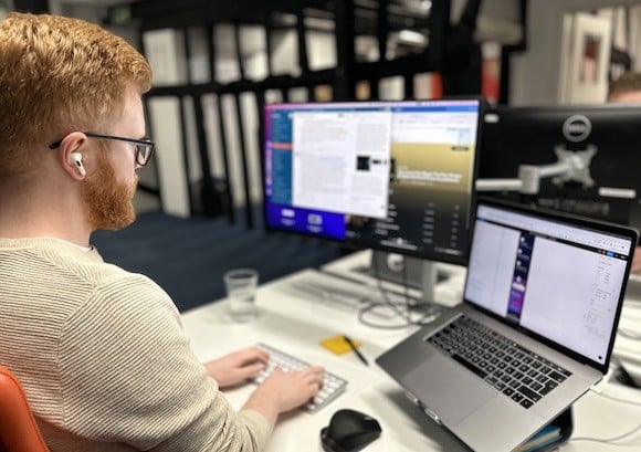 A developer working on two screens.