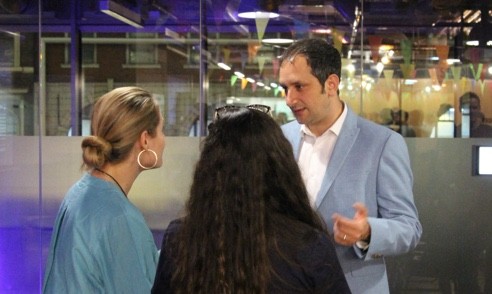 Our CEO, Danny chatting with a couple of people in a conference 